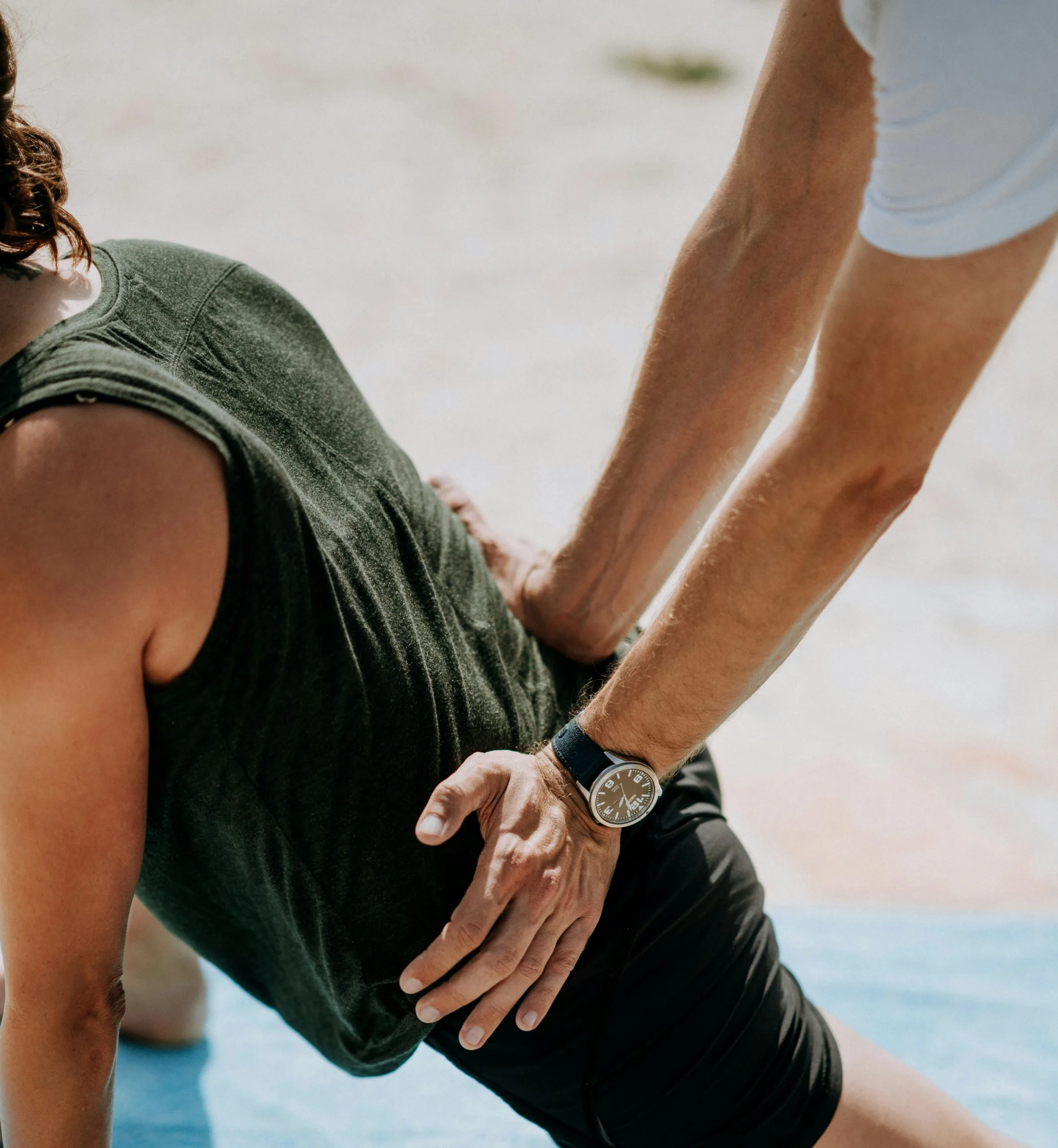 A man helping a man in physical therapy